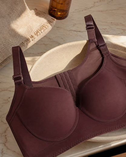 The Ease wireless smoothing bra in Burgundy on a pale marble vanity