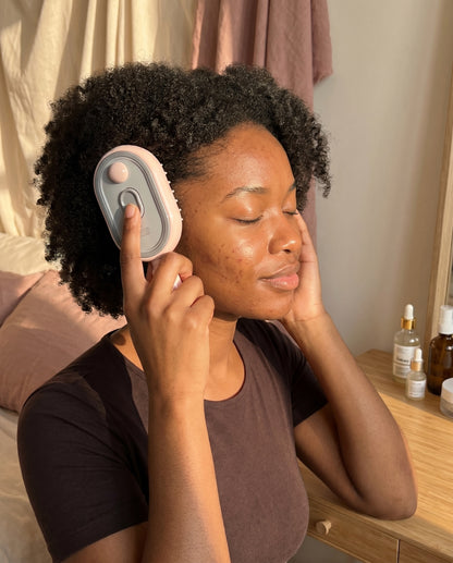 Woman giving herself a relaxing scalp massage with The Cloud