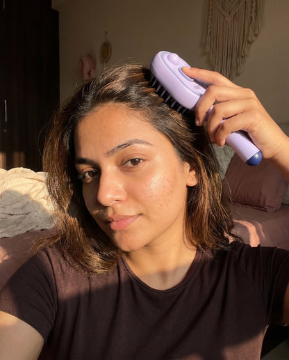 Woman using the Lavender Cloud scalp massage brush at home