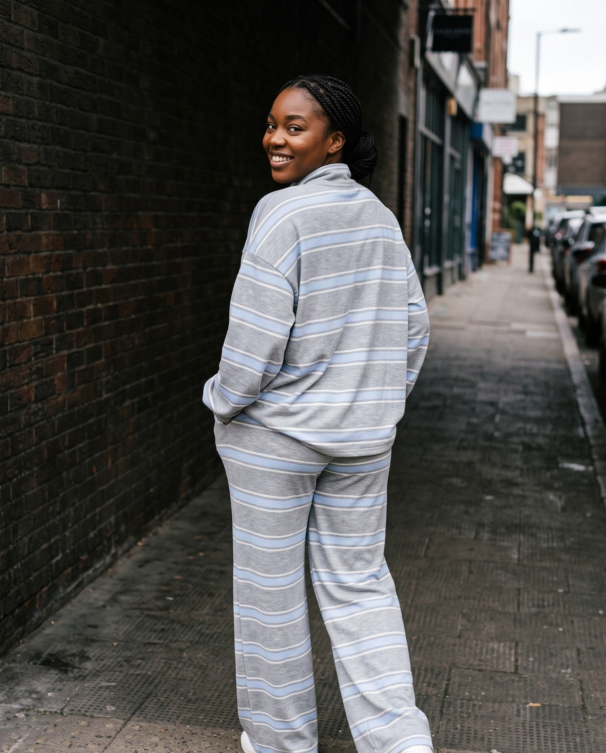 Back view of The Sunday striped lounge set in Gray, showing the oversized top and wide-leg pants
