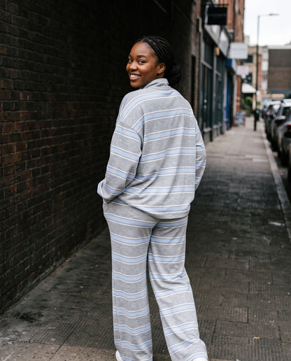 Back view of The Sunday striped lounge set in Gray, showing the oversized top and wide-leg pants