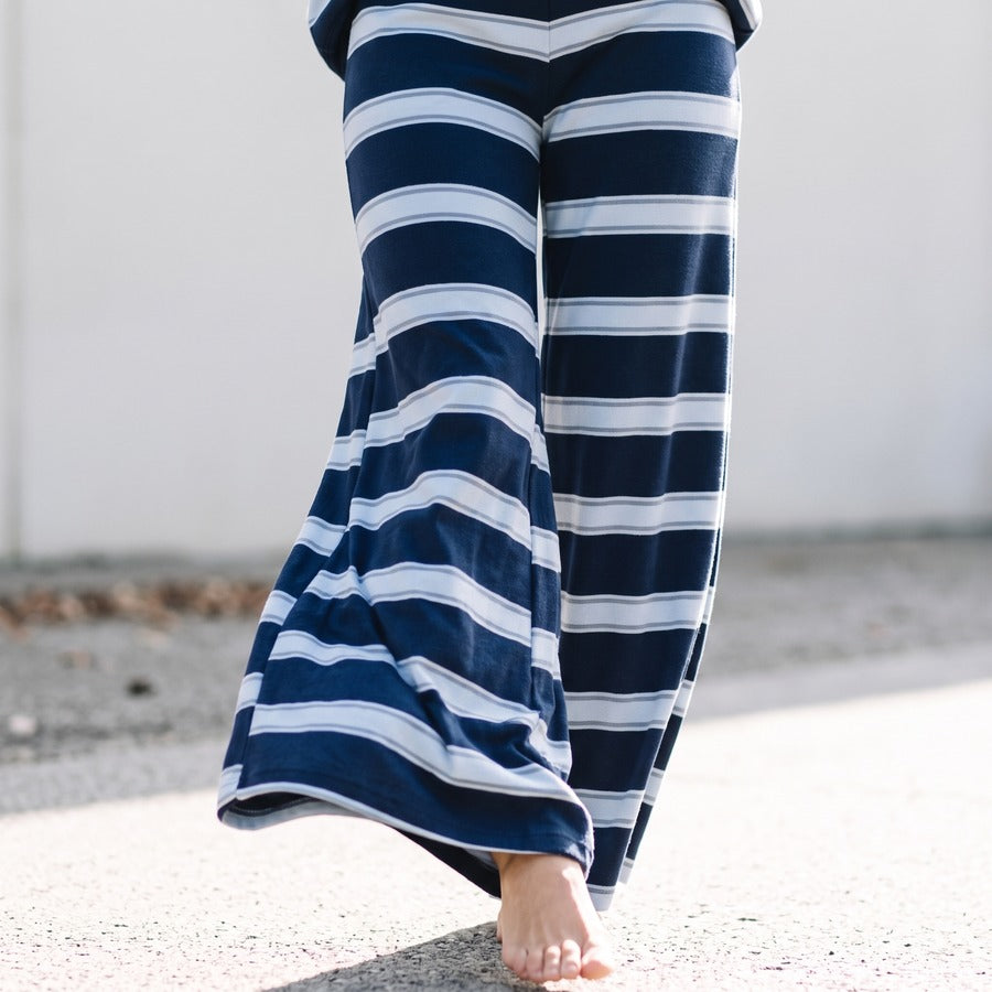 The wide leg caught mid-stride in Dark Blue, showing the drape